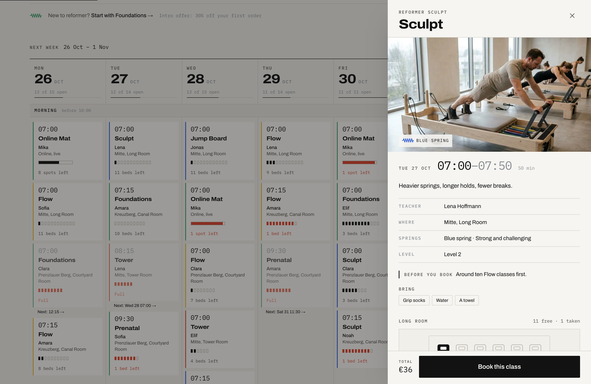 The class sheet for Sculpt on Tue 27 Oct, 07:00 to 07:50, sliding over the timetable: Blue spring, Lena Hoffmann in the Mitte Long Room, Level 2, 'Before you book: around ten Flow classes first', what to bring, the room drawn bed by bed with 11 free and 1 taken, and a Book this class button at €36
